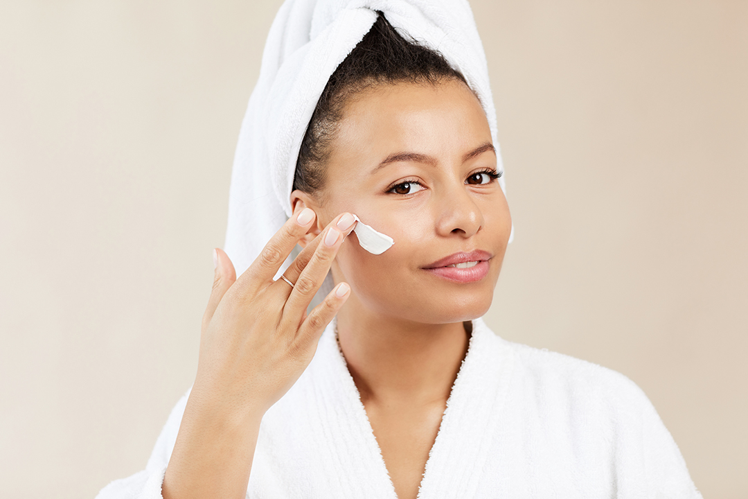 Beautiful Woman Applying Face Cream